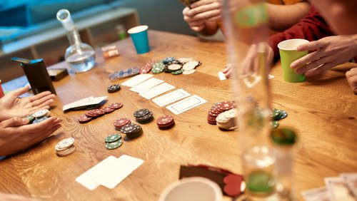 cards and poker chips on table with bongs