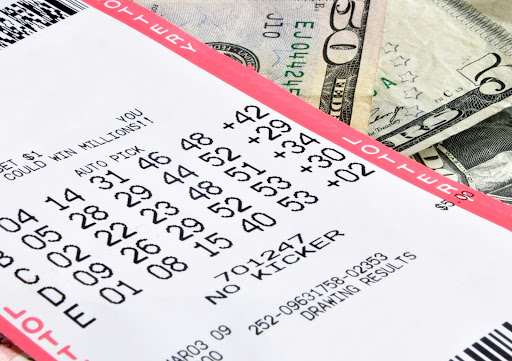 lottery ticket on fifty dollar bills