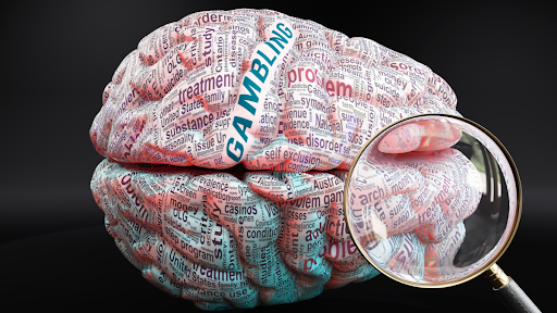 magnifying glass in front of brain with the words gambling problem printed on it